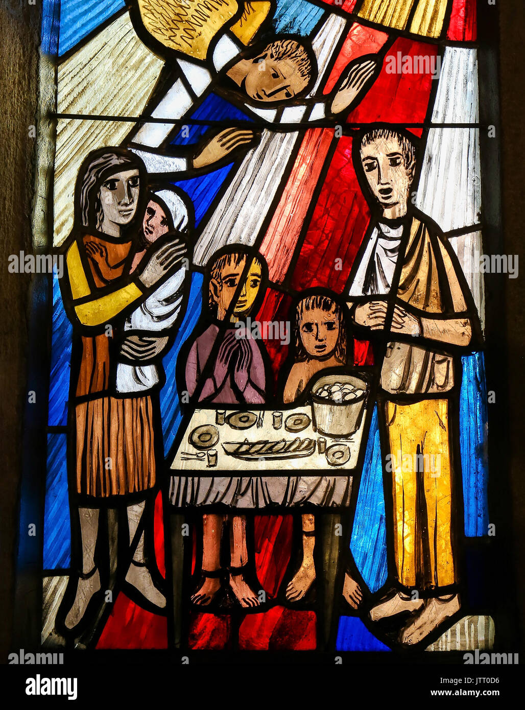Stained Glass in the Stiftskirche Church in Tubingen, Baden-Wurttemberg, Germany, depicting a family gathered around a table, praying Stock Photo