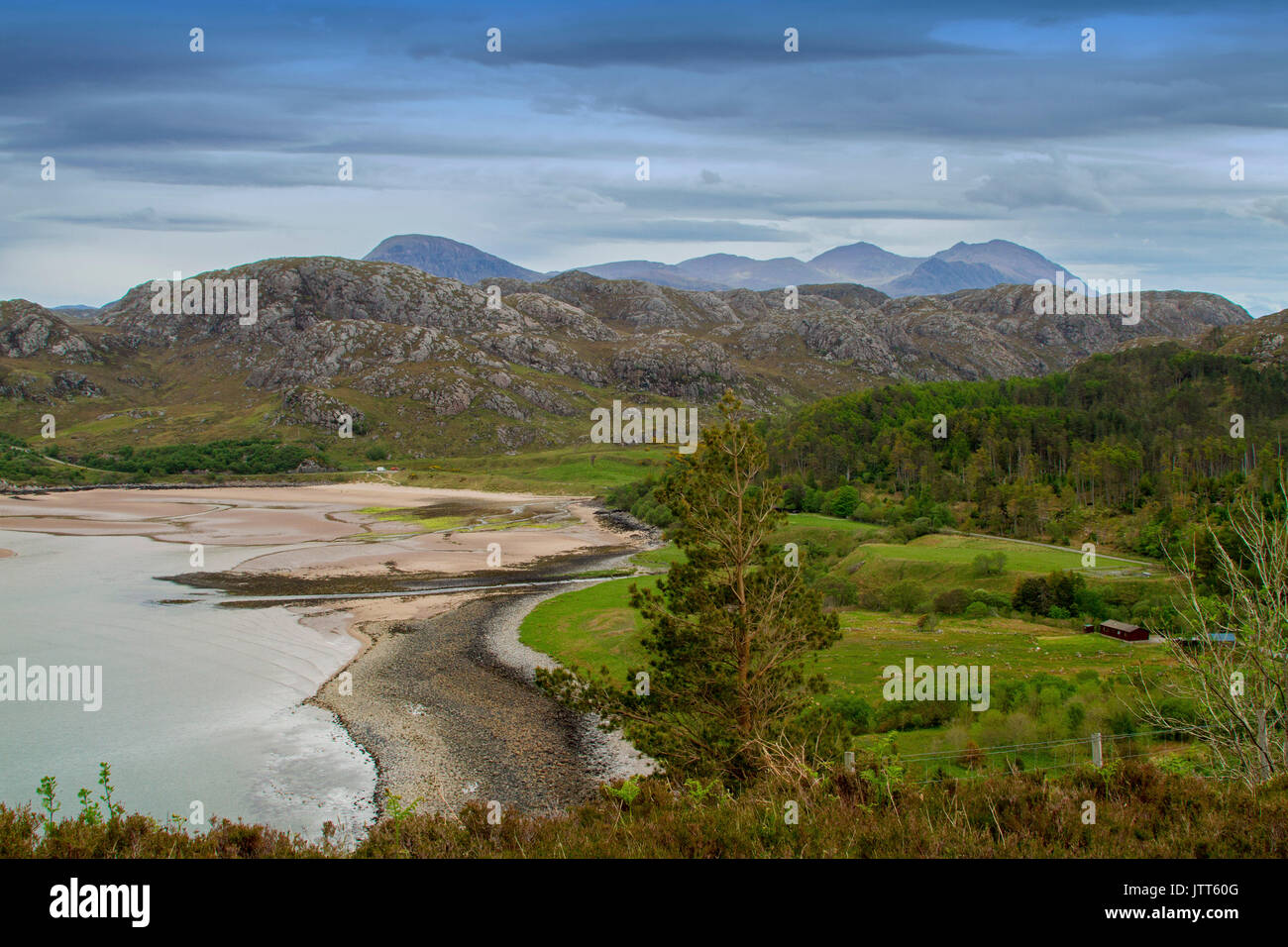 Vast and stunning coastal andscape dominated by beach and mountains near Poolewe, Scotland Stock Photo