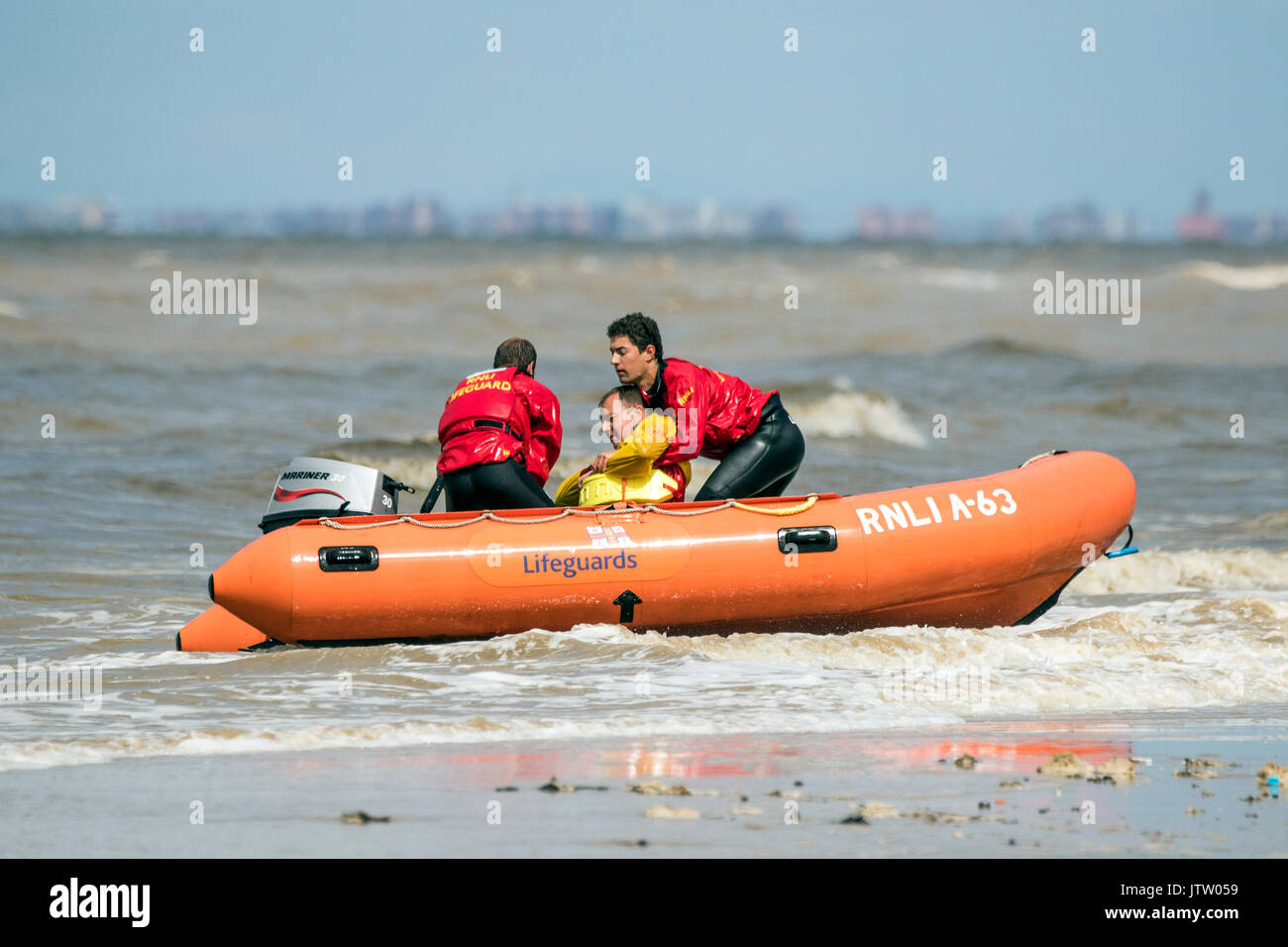 Rnli lifeguard training, sea save rescue rescuer emergency drown drowning water tide tides safety coast swim swimmer swimming guard saver life beach Southport seaside, UK Stock Photo