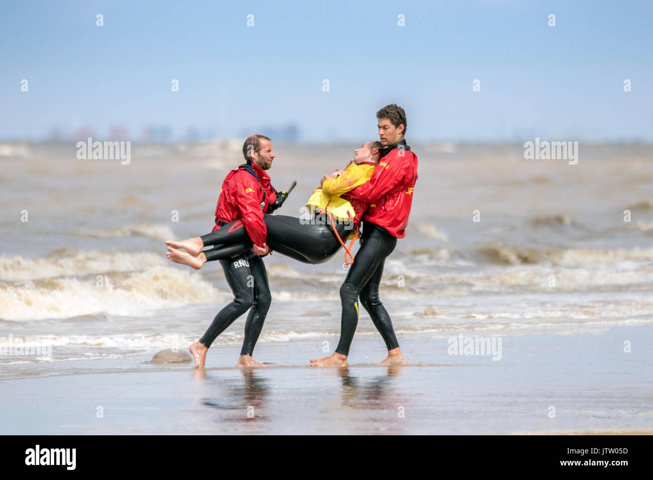 rnli lifeguard sea save rescue rescuer emergency drown drowning water tide tides safety coast swim swimmer swimming guard saver life beach seaside Stock Photo