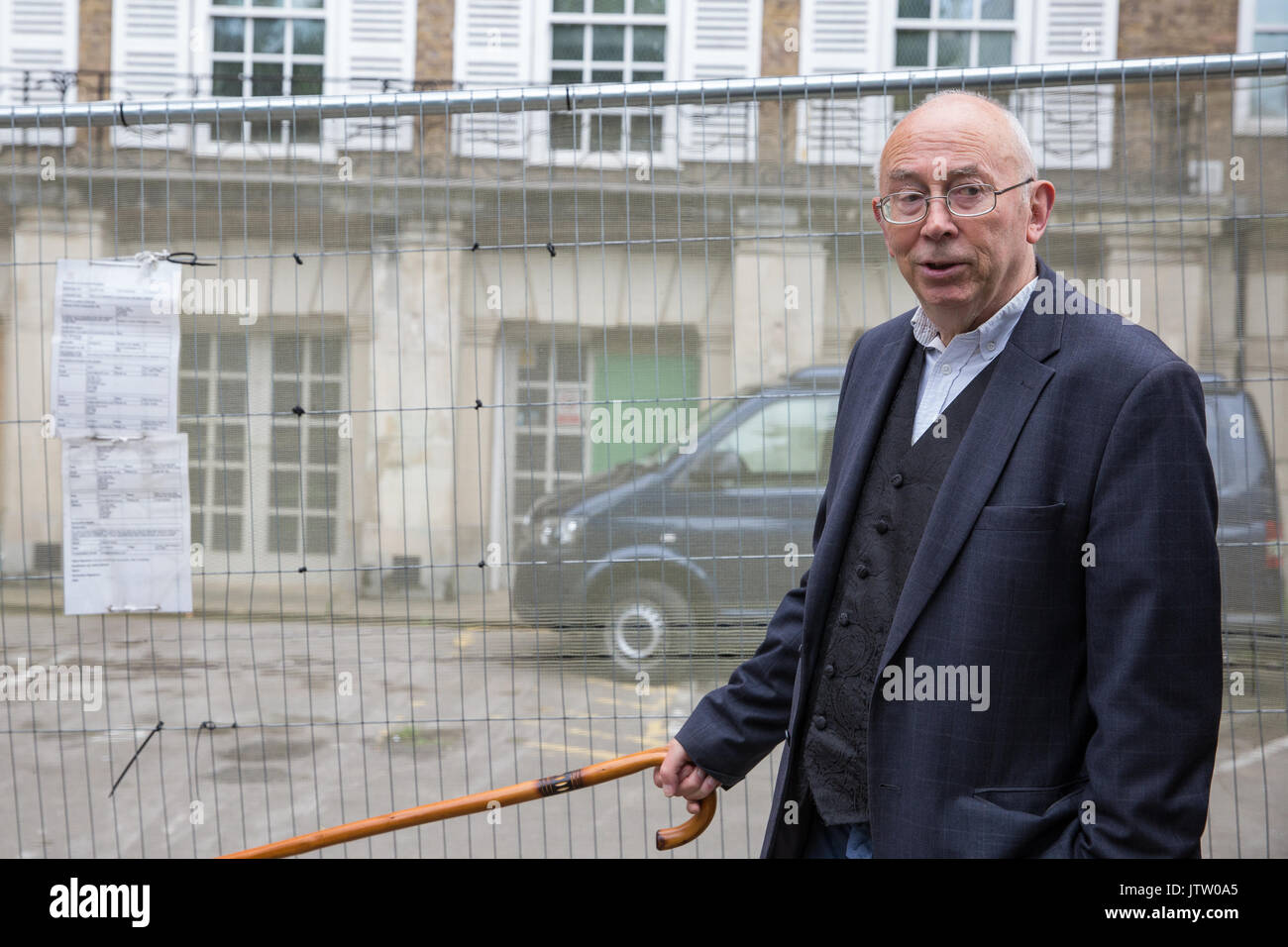 London, UK. 10th August, 2017. Ian Bone of Class War is interviewed during a protest outside Duke's Lodge in Holland Park, an empty apartment block believed to be owned by Christian Candy’s Guernsey-based CPC Group, to draw attention to social housing required by former residents of the Grenfell block in North Kensington. Credit: Mark Kerrison/Alamy Live News Stock Photo