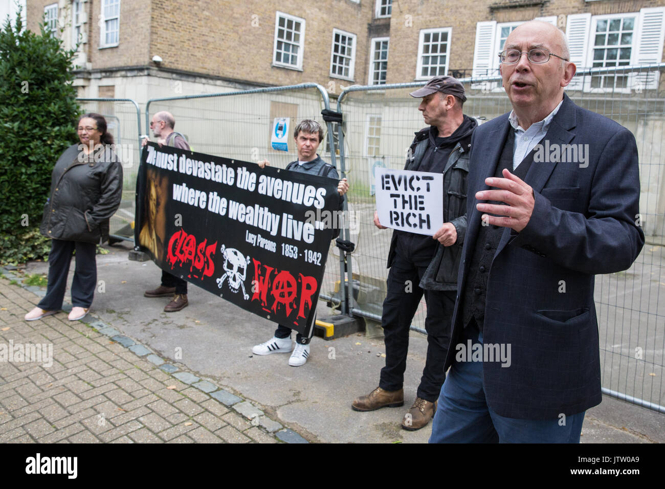 London, UK. 10th August, 2017. Ian Bone of Class War is interviewed during a protest outside Duke's Lodge in Holland Park, an empty apartment block believed to be owned by Christian Candy’s Guernsey-based CPC Group, to draw attention to social housing required by former residents of the Grenfell block in North Kensington. Credit: Mark Kerrison/Alamy Live News Stock Photo