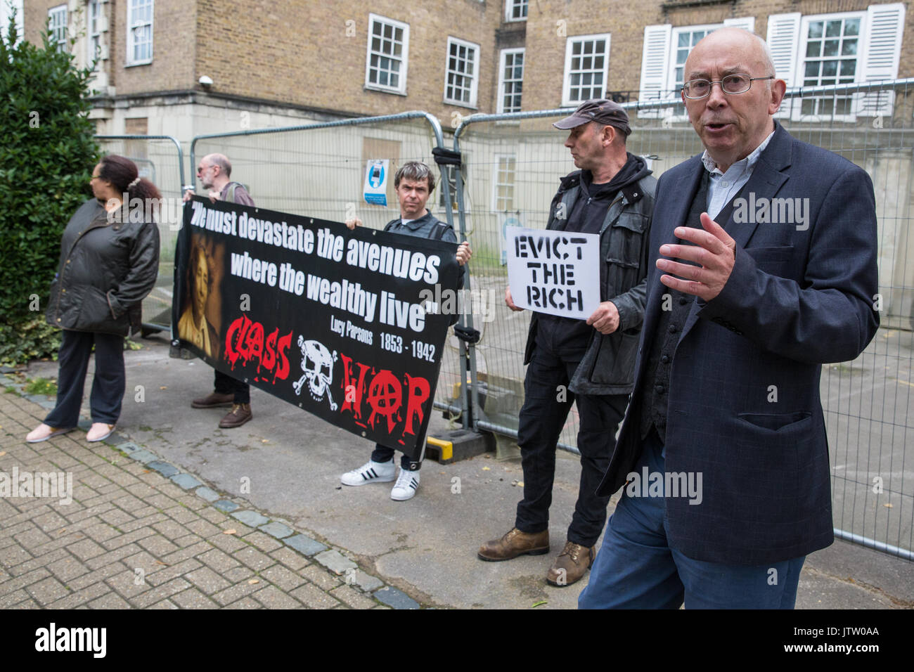London, UK. 10th August, 2017. Ian Bone of Class War is interviewed during a protest outside Duke's Lodge in Holland Park, an empty apartment block believed to be owned by Christian Candy’s Guernsey-based CPC Group, to draw attention to social housing required by former residents of the Grenfell block in North Kensington. Credit: Mark Kerrison/Alamy Live News Stock Photo