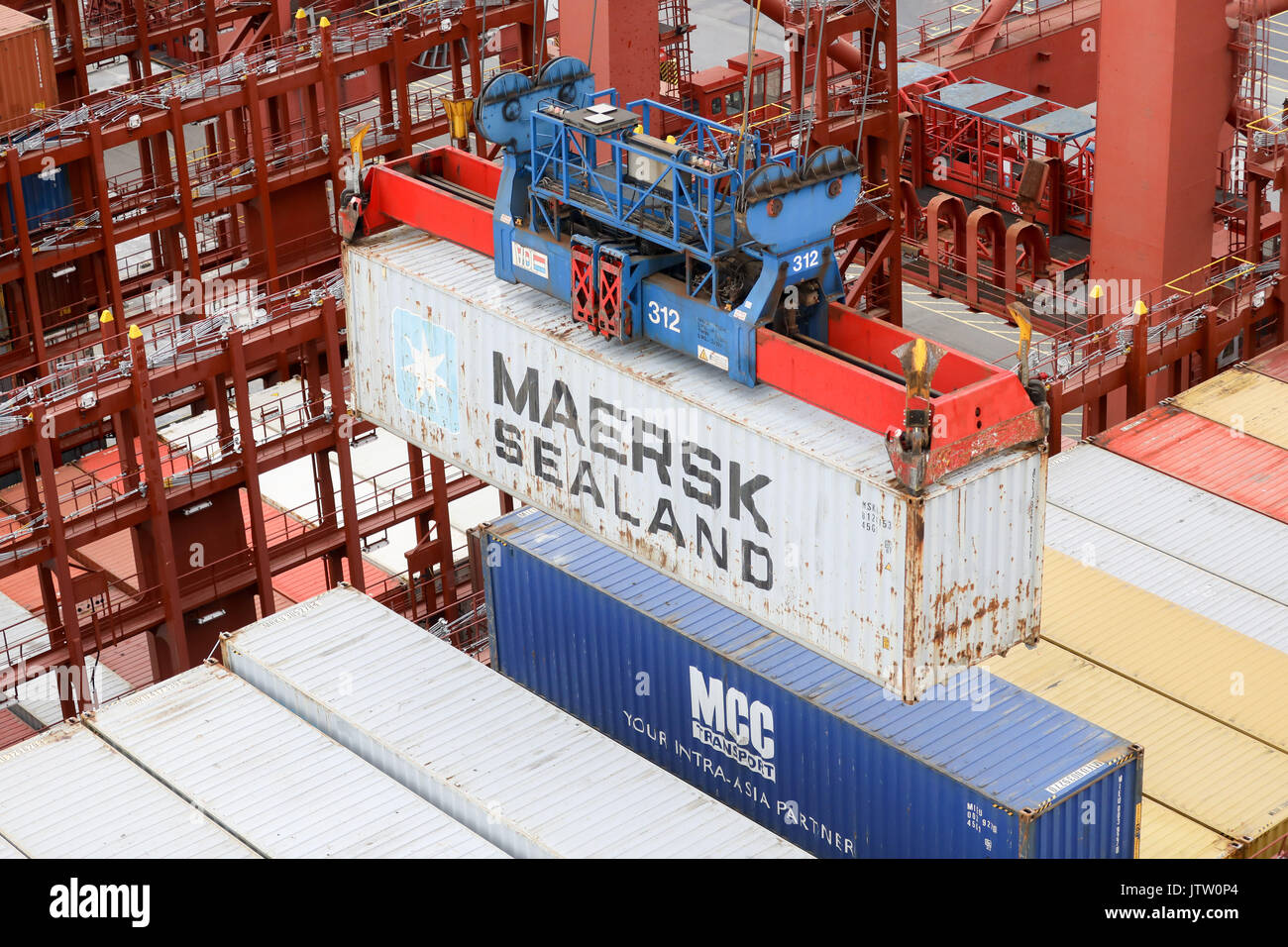 Hamburg, Germany. 05th Aug, 2017. The container behemoth 'Munich Maersk' is being unloaded at the Eurogate Terminal in the harbour of Hamburg, Germany, 05 August 2017. The container behemoth can carry 20,568 standard containers (TEU) and is thus the largest container ship ever to call at Hamburg. The 'Munich Maersk' belongs to the second generation of the 'Triple E Class'. The three Es stand of Efficiency, Economy of Scale and Environment. They are among the most modern transport ships in the world. Photo: Christian Charisius/dpa/Alamy Live News Stock Photo