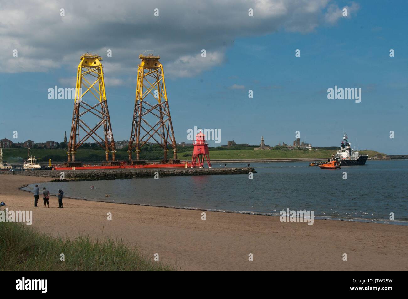River Tyne, South Shields, UK, 10th August 2017. Wind turbine foundations being towed past The Groyne, South Shields on their way to the Beatrice offshore wind farm in the Moray Firth. Due to their height National Grid had to raise the height of power cables across the River Tyne despite the pylons being two of the highest in Britain, surpassed only by sets spanning the River Thames near London and the River Severn in Bristol. Credit: Colin Edwards/Alamy Live News. Stock Photo
