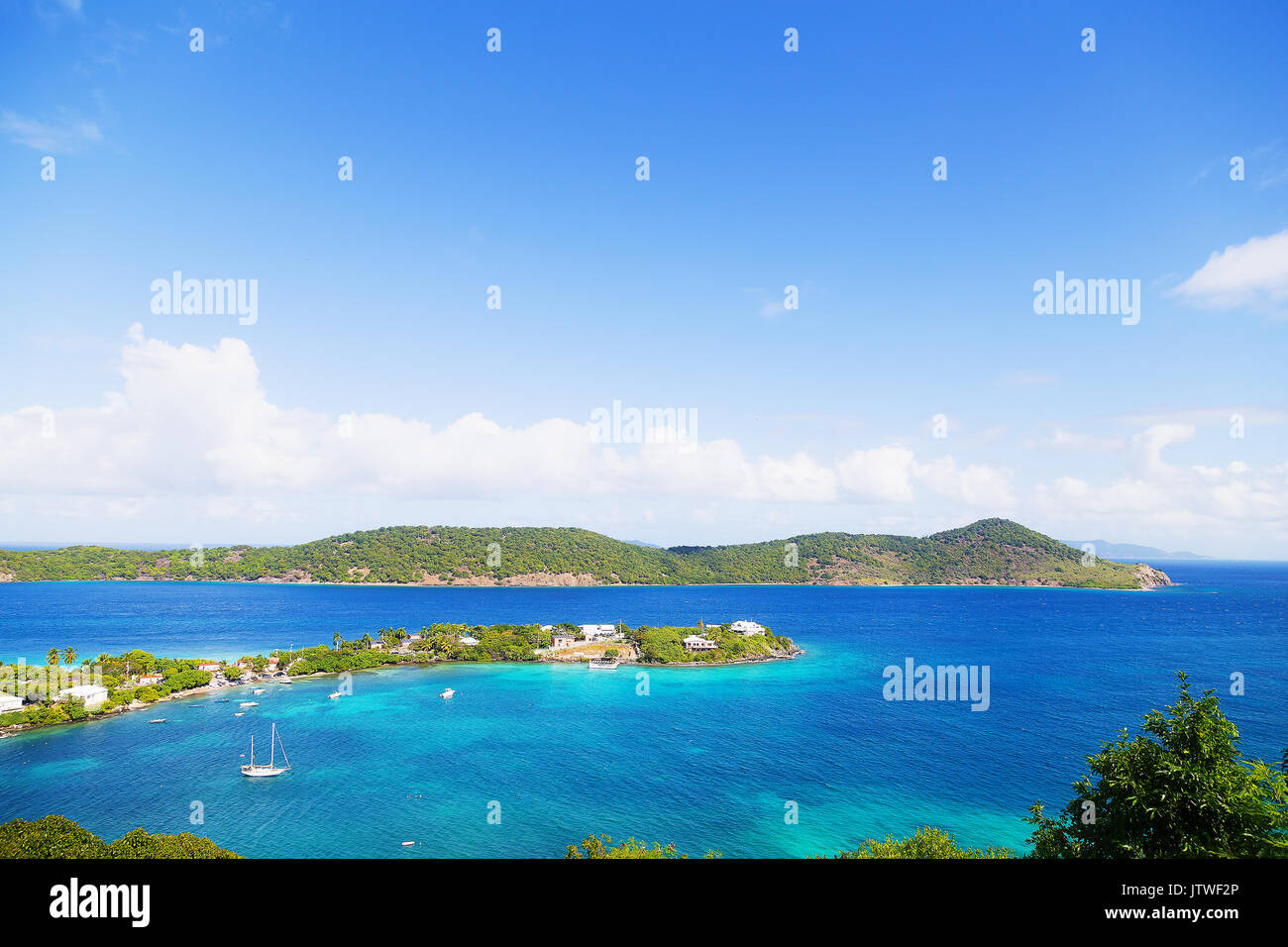 Tropical island lagoon and boats moored in shallow waters, St Thomas, US VI. Early morning on St Thomas Island near Aquarian and Coki Beach. Stock Photo