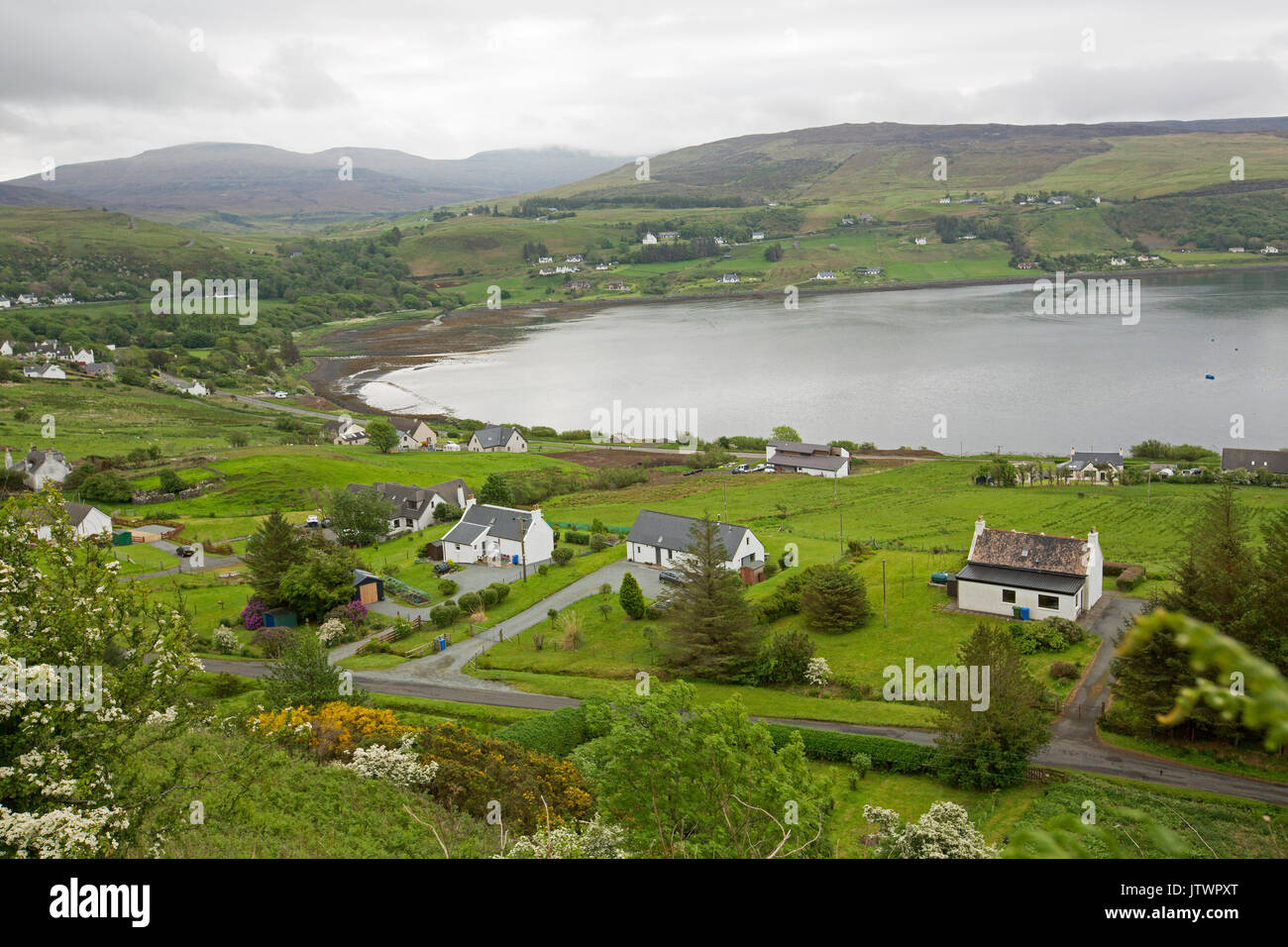Vast view, from high lookout, of town and harbour surrounded by hills and mountains at Uig, Isle of Skye, Scotland Stock Photo