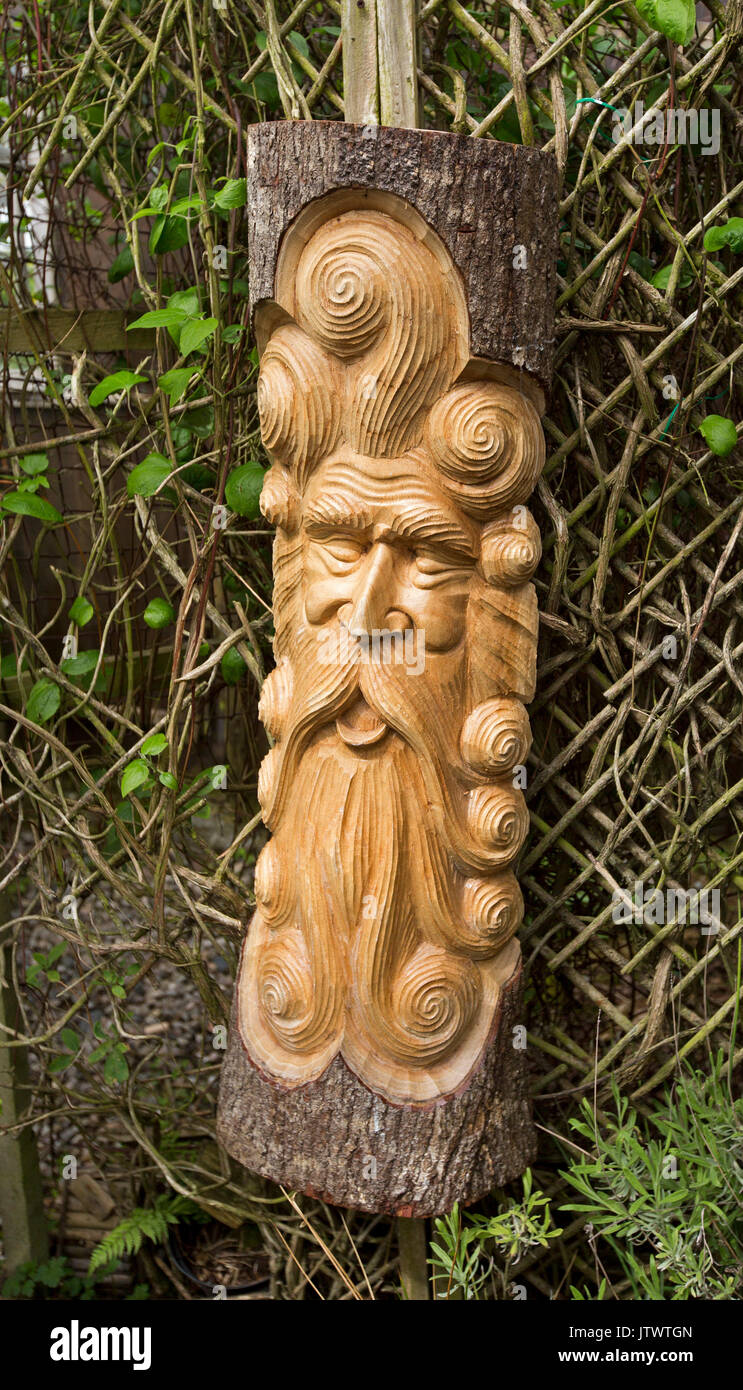 Hand made wooden carving of old man's face with beard Stock Photo