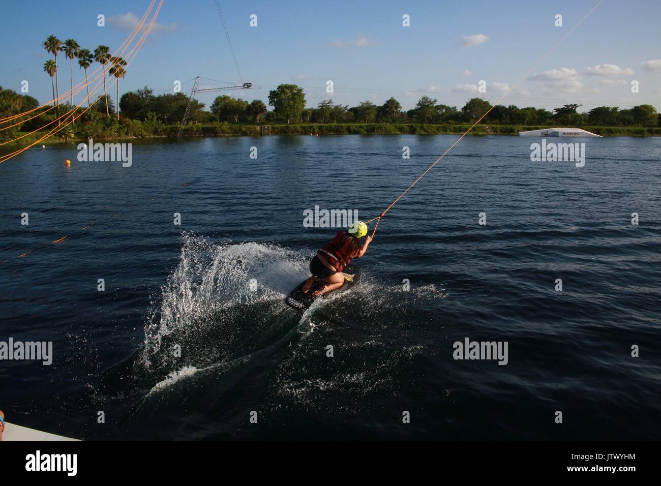 Girl on Kneeboard Being Launched Pulled Out into Lake by Cable in a