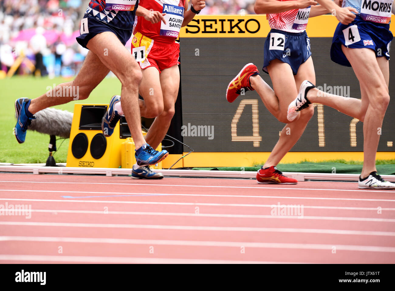 Runner's legs passing the Seiko timing clock. Space for copy Stock Photo -  Alamy