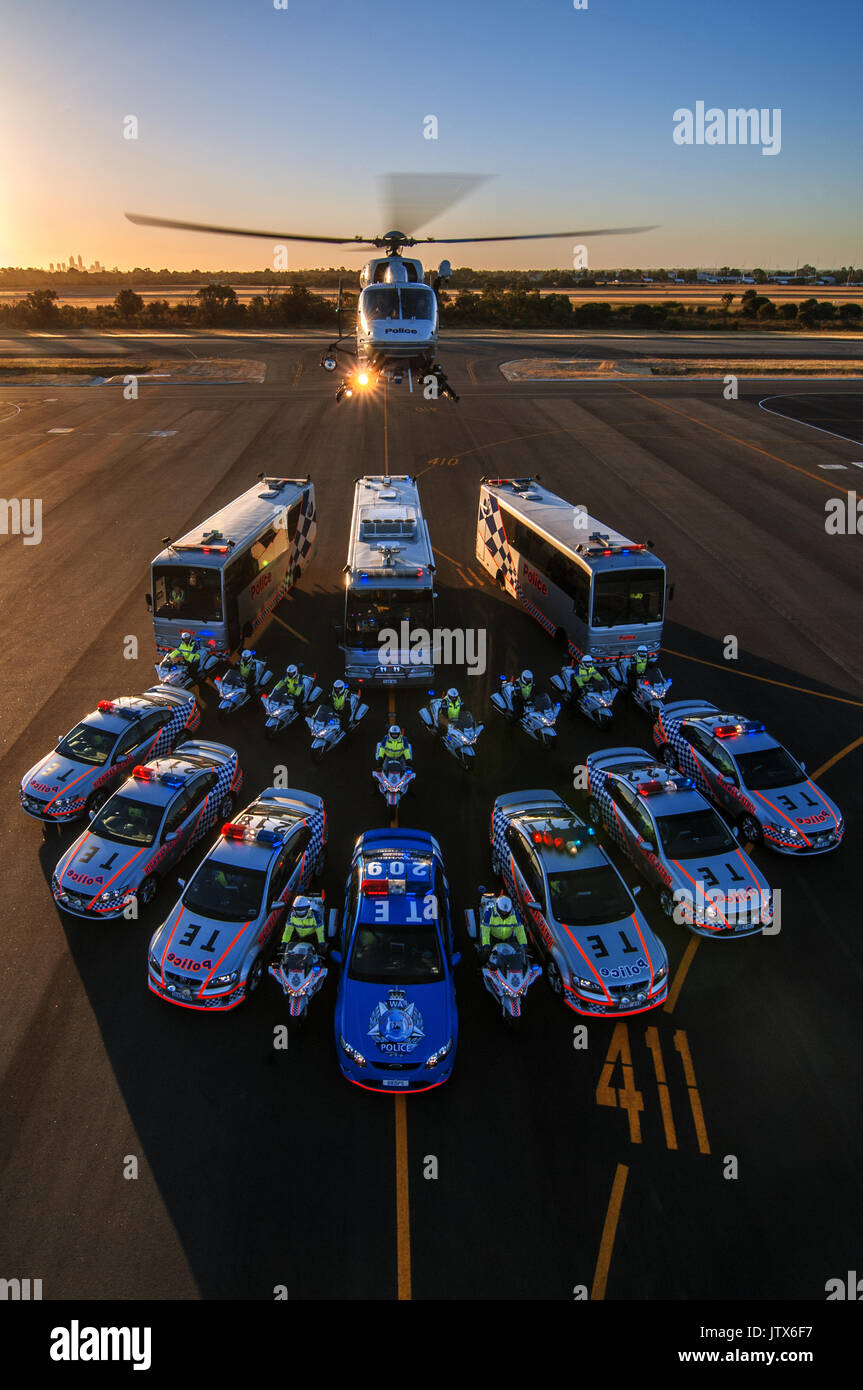 Portrait view at dusk, of the Western Australian Police traffic section, complete with their BK117 helicopter. Taken from on top of a crane. Stock Photo