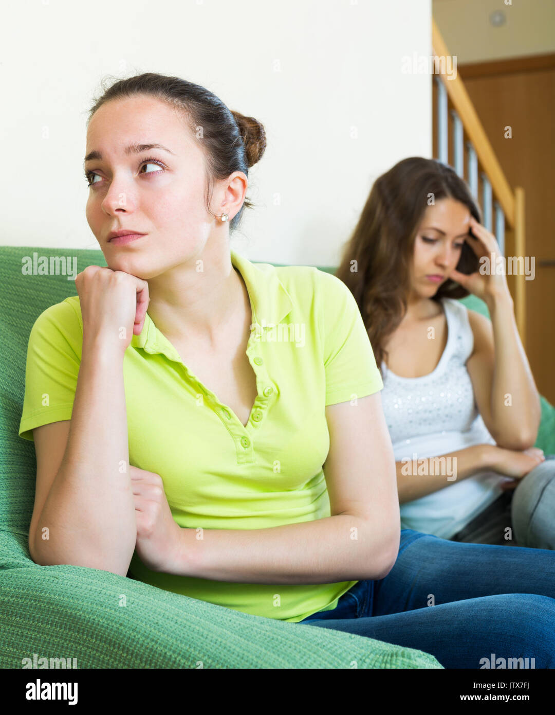 Two sad girls having conflict at home Stock Photo