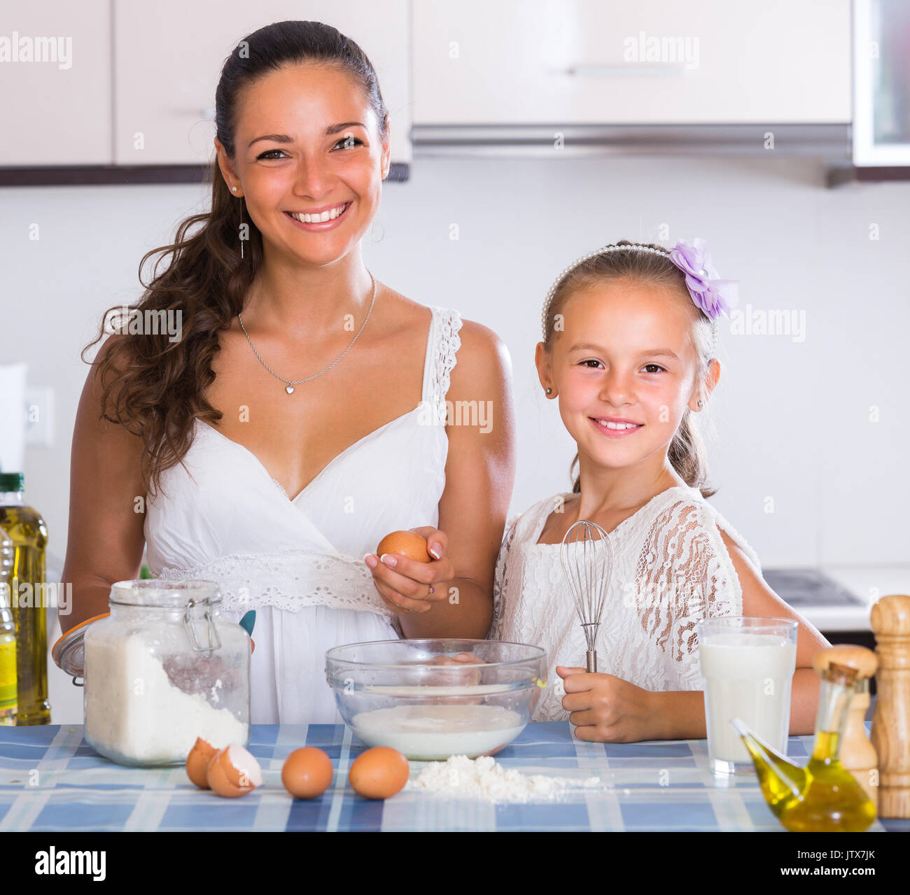 Happy little girl help mom cooking in kitchen Stock Photo - Alamy