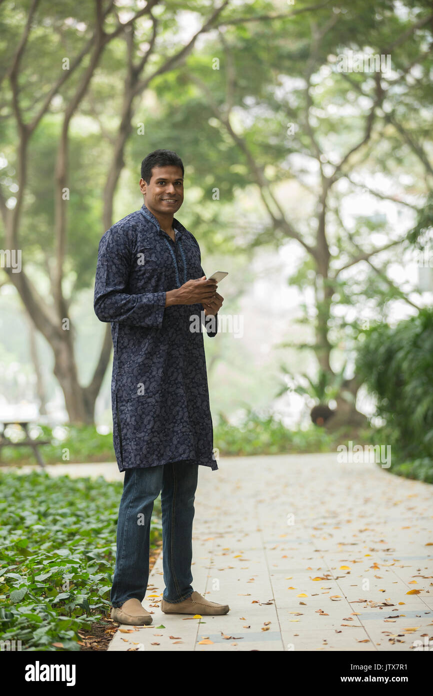 Happy indian man outdoors. portrait of an indian man wearing a Traditional kurta. Stock Photo