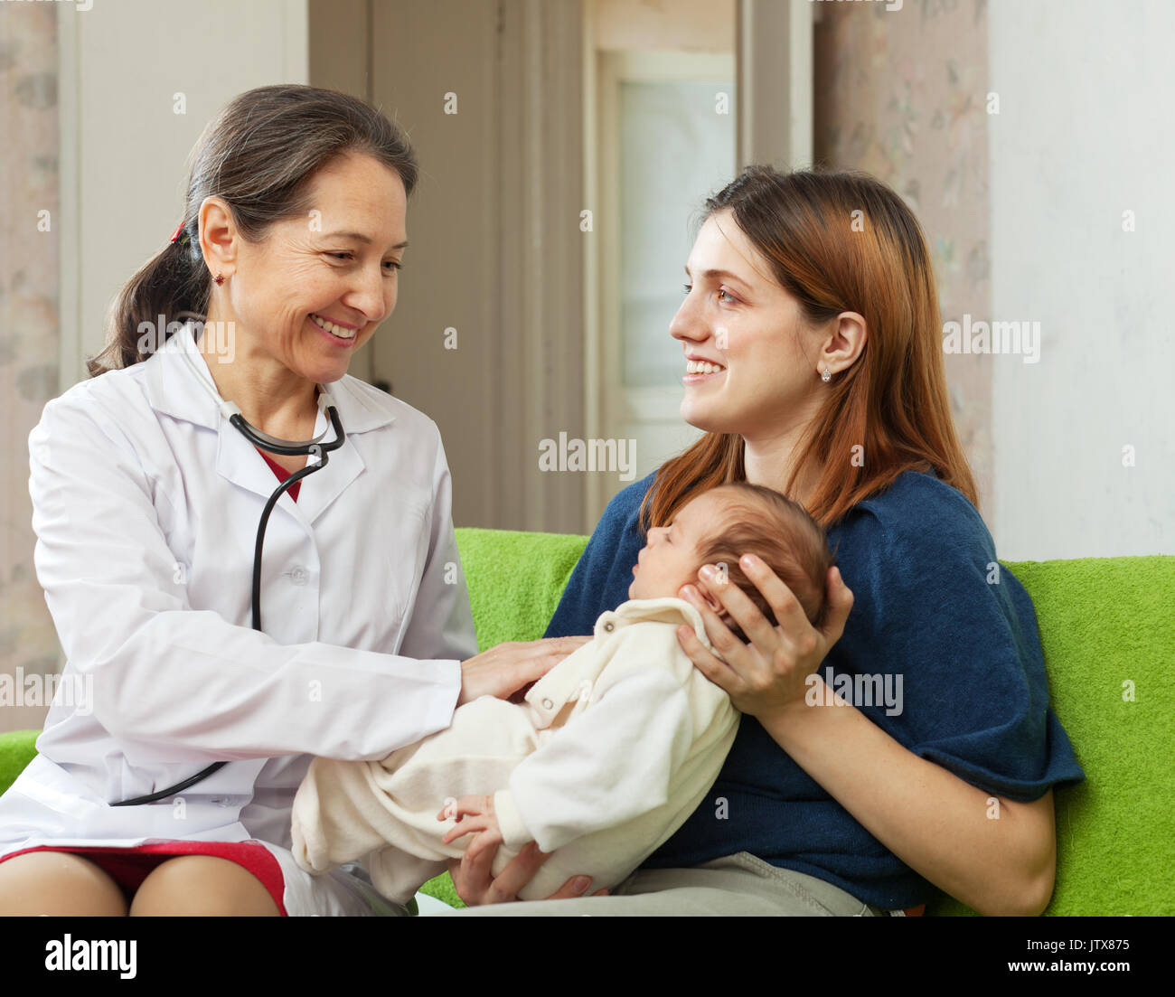 mature pediatrician doctor examining newborn baby Stock Photo - Alamy