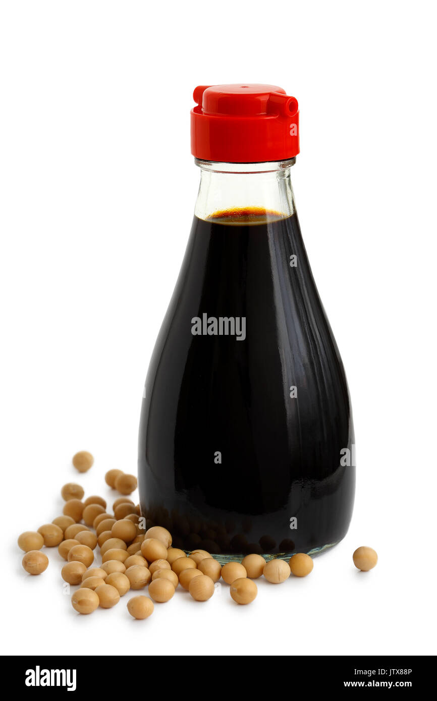 Glass bottle of soya sauce with red plastic lid isolated on white