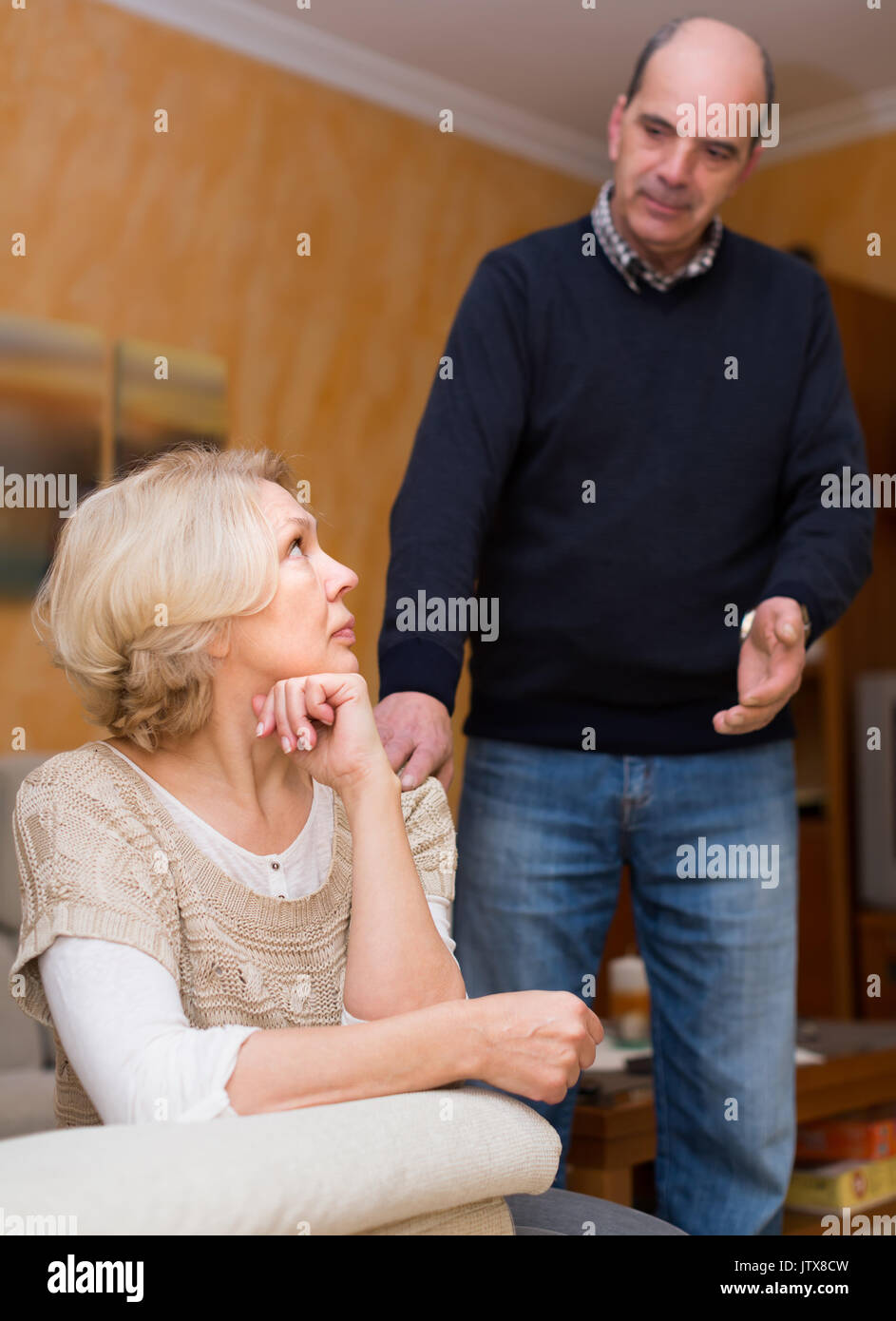 Angry senior woman and man after quarrel at home. Focus on woman Stock ...