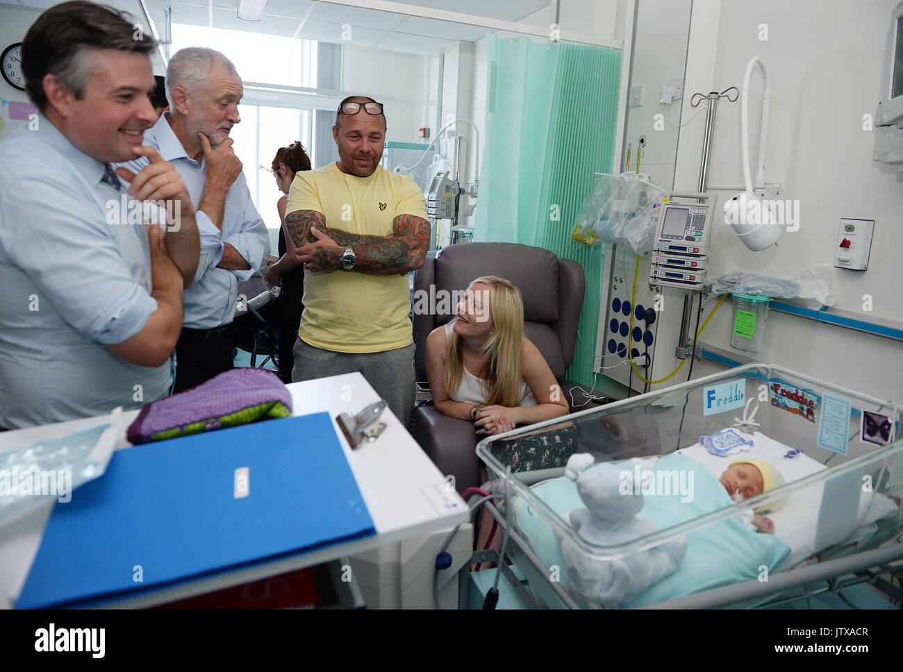 Labour leader Jeremy Corbyn and Shadow Health Secretary Jonathan Ashworth (left)meet Paul and Emma Drinkwater and their son Freddie who is 16 days old, in the Neonatal Unit at the Royal Cornwall Hospital in Treliske, Truro. Stock Photo