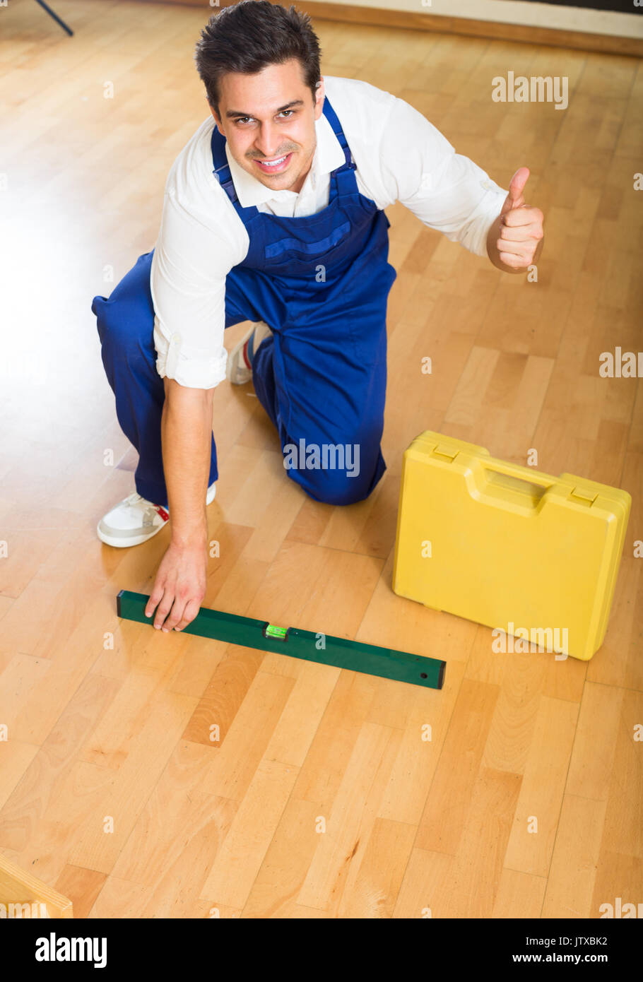 Constructor Fixing Laminate Flooring In Apartment Stock Photo
