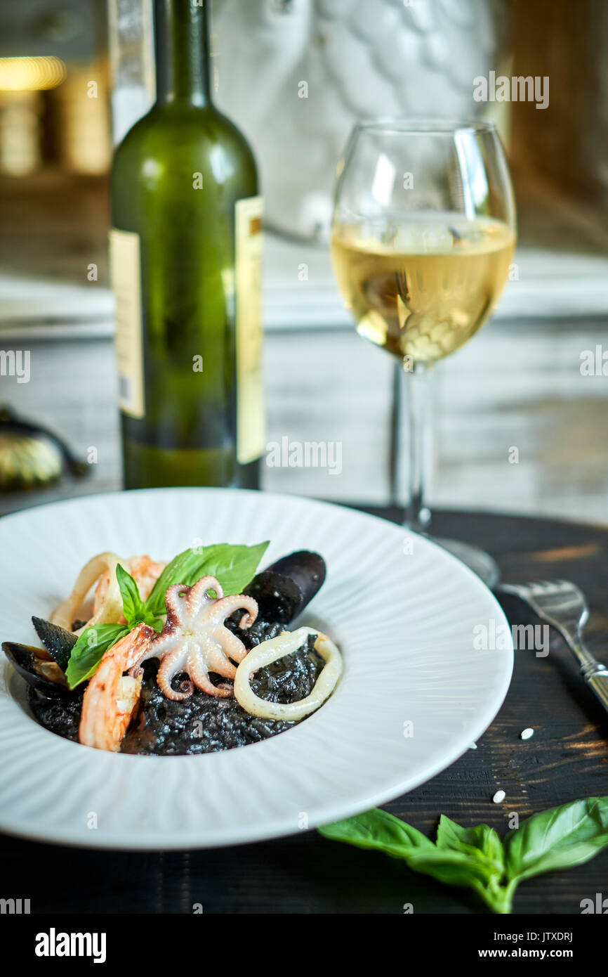 Dish of risotto with squid ink on grey plate jpg Stock Photo - Alamy