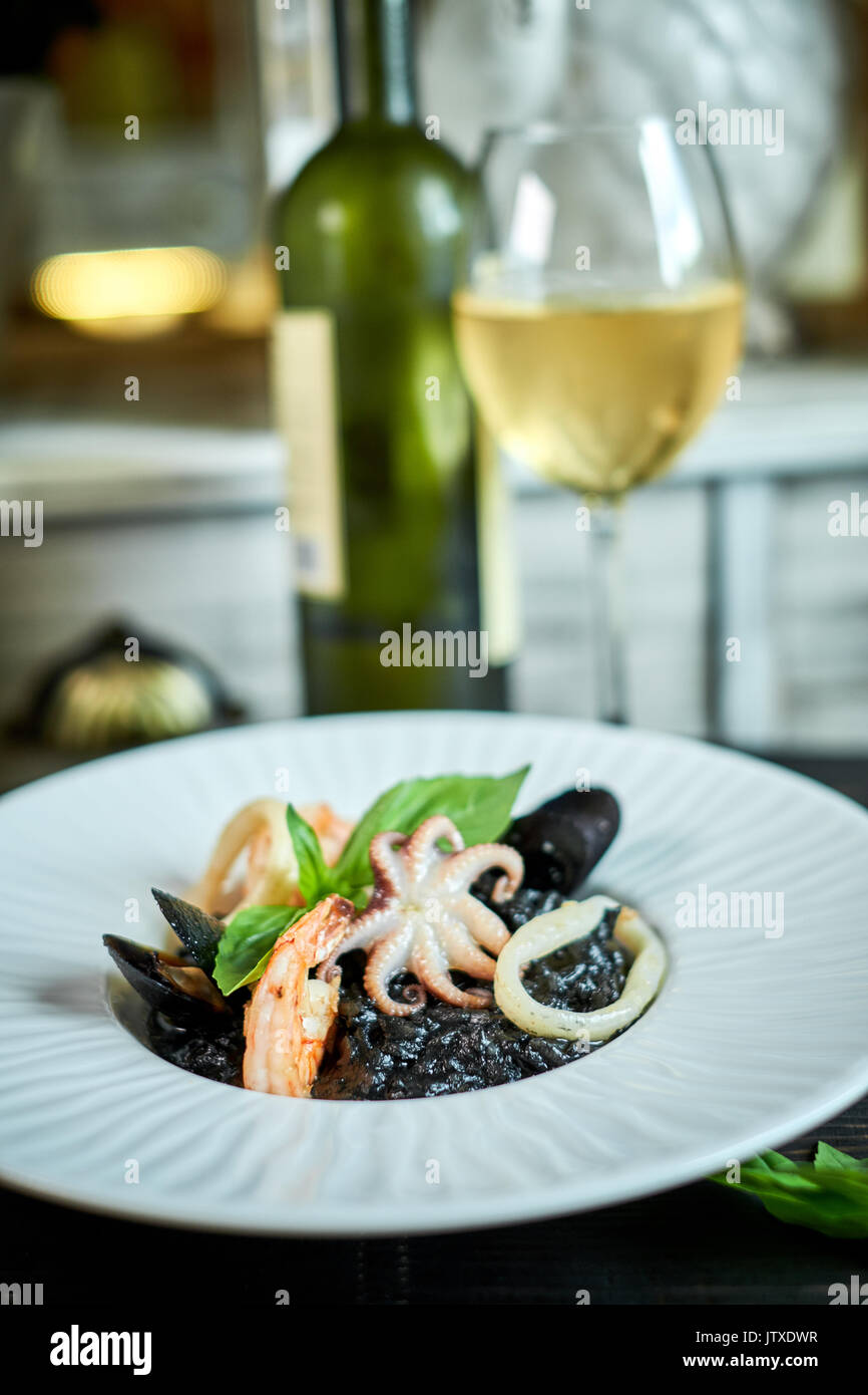 Dish of risotto with squid ink on grey plate jpg Stock Photo