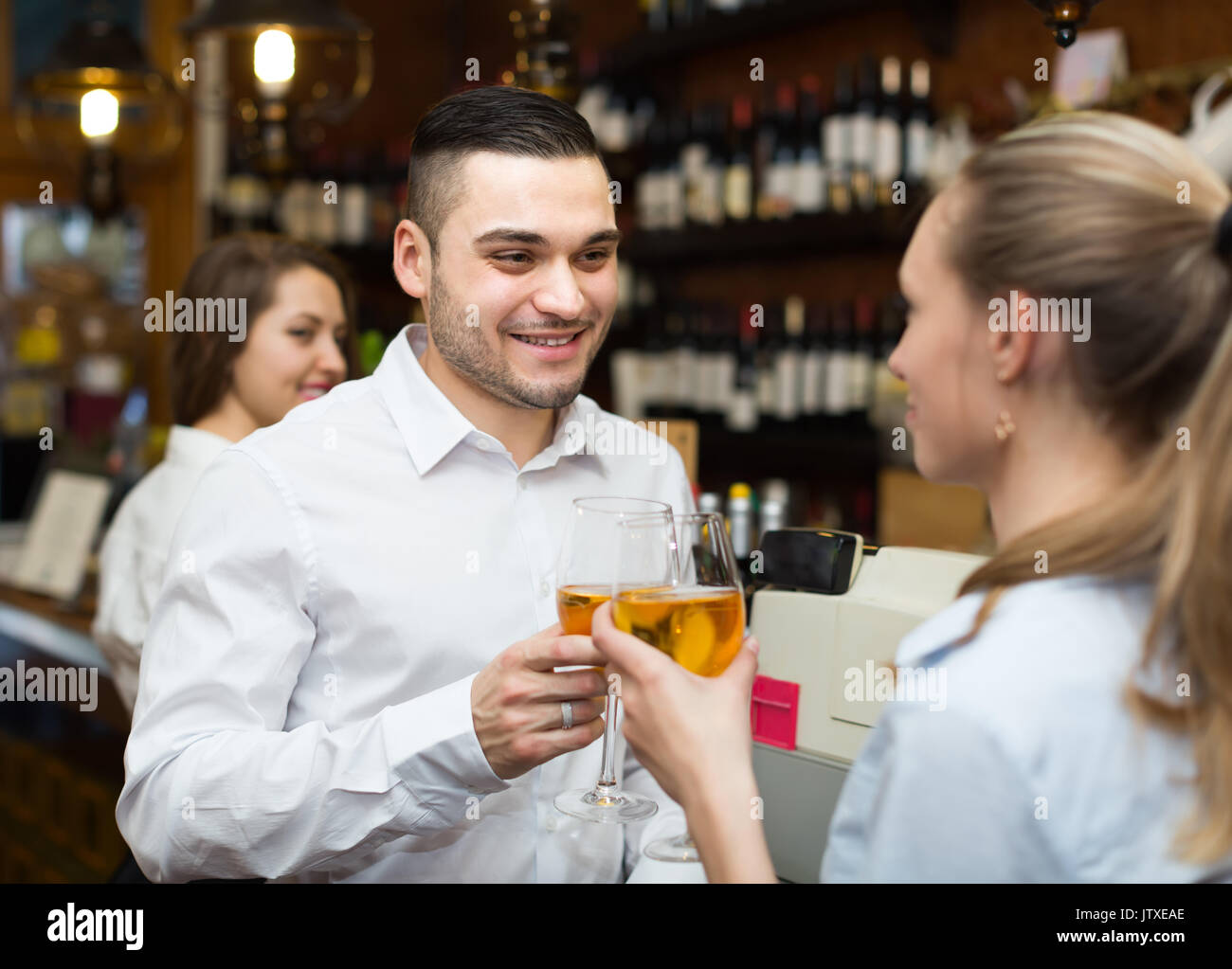 Date of young couple drinking wine at counter in bar and smiling Stock ...