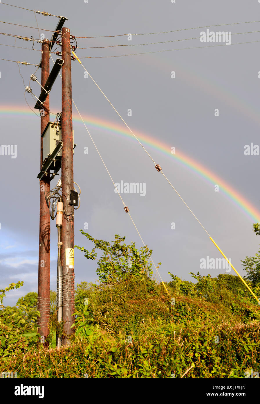 Double rainbow against grey skies amid intermittent showers. Stock Photo