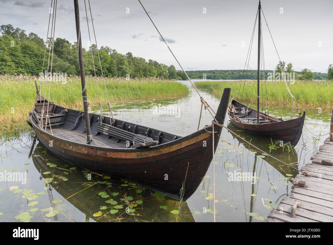 Replicas of viking ships at the Birka outdoor museum. Birka is situated on the island of Björkö in Lake Mälaren, west of Stockholm. Stock Photo