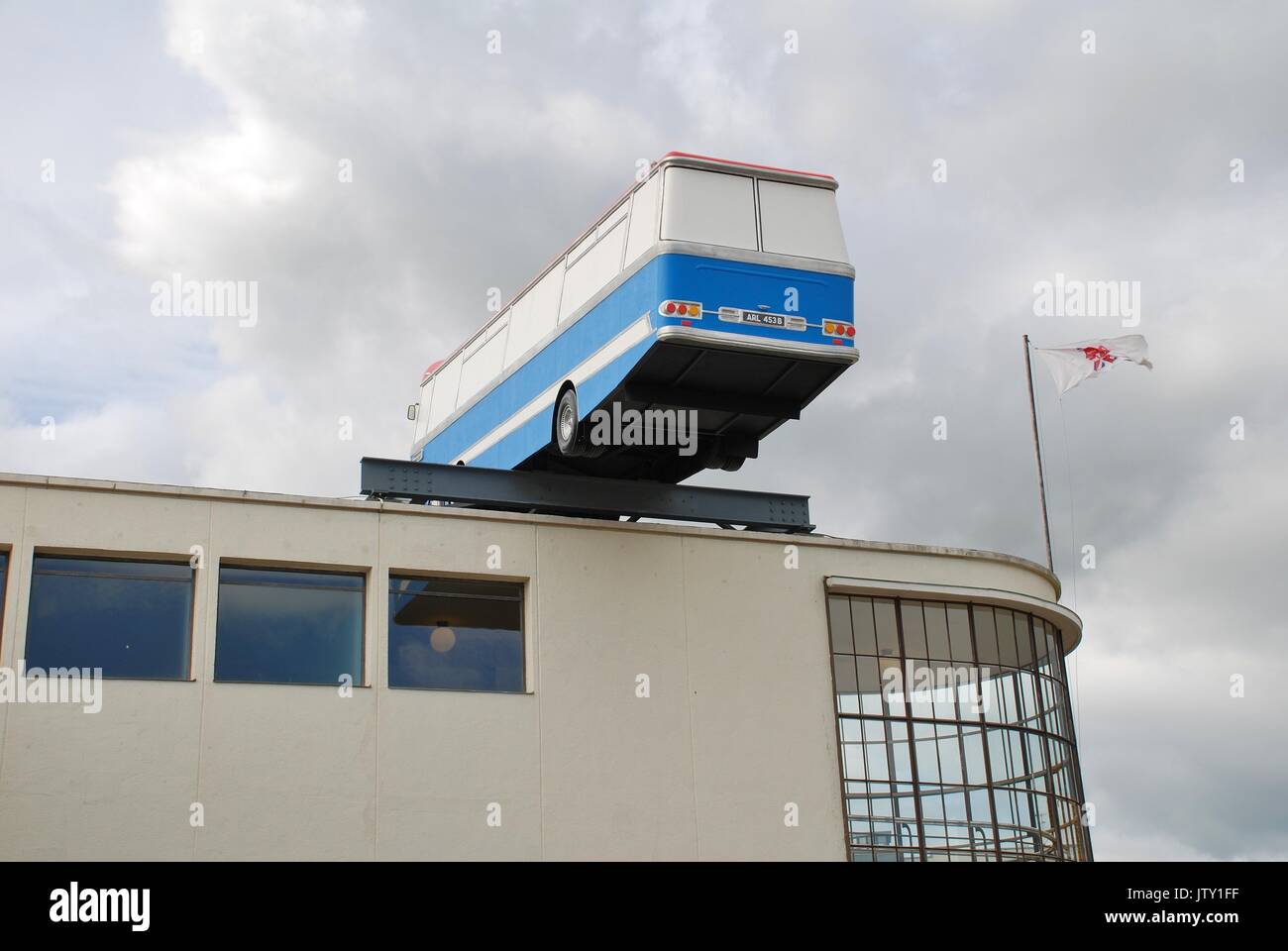 An art installation of a replica coach by artist Richard Wilson on top of the De La Warr pavilion in Bexhill-on-Sea, England on September 12, 2012. Stock Photo