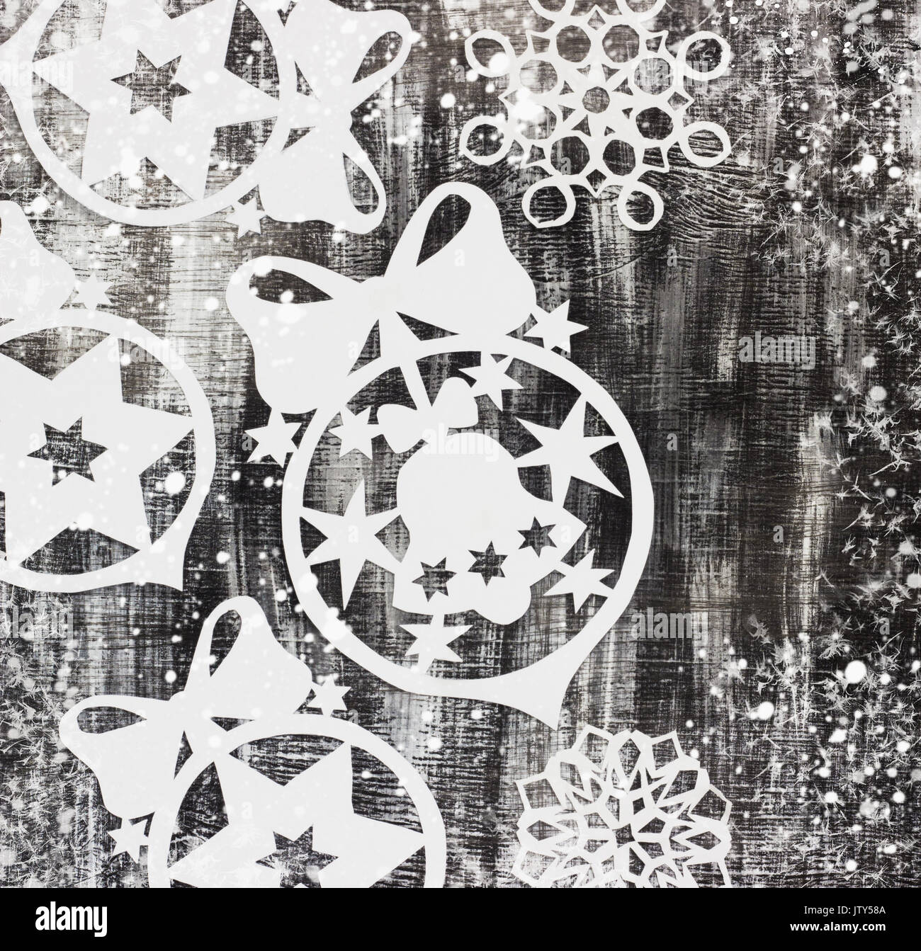 Snowflakes cut out of paper on dark old background with space for text ...