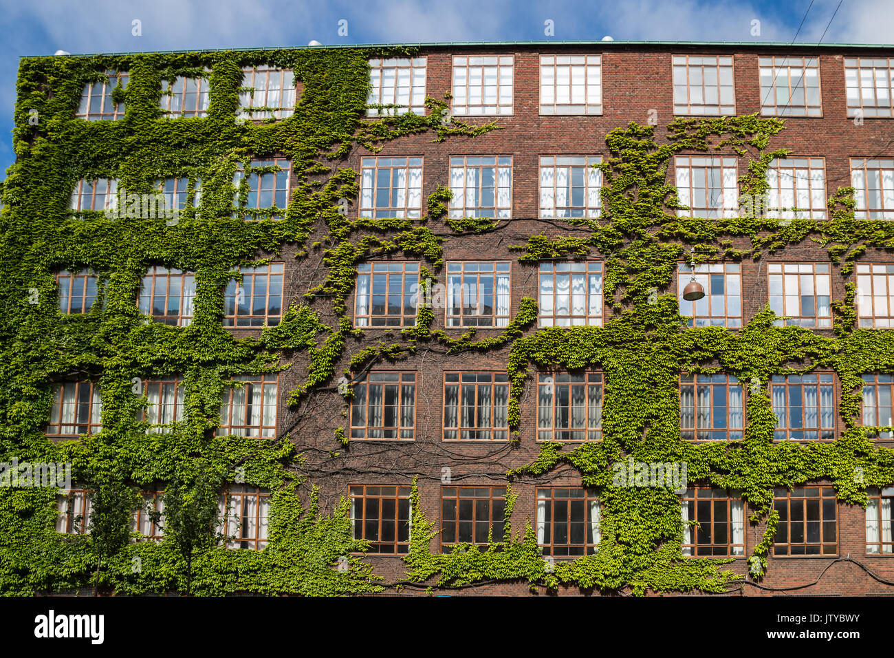 Facade of red brick Building with multiple Windows, Copenhagen, Europe Stock Photo
