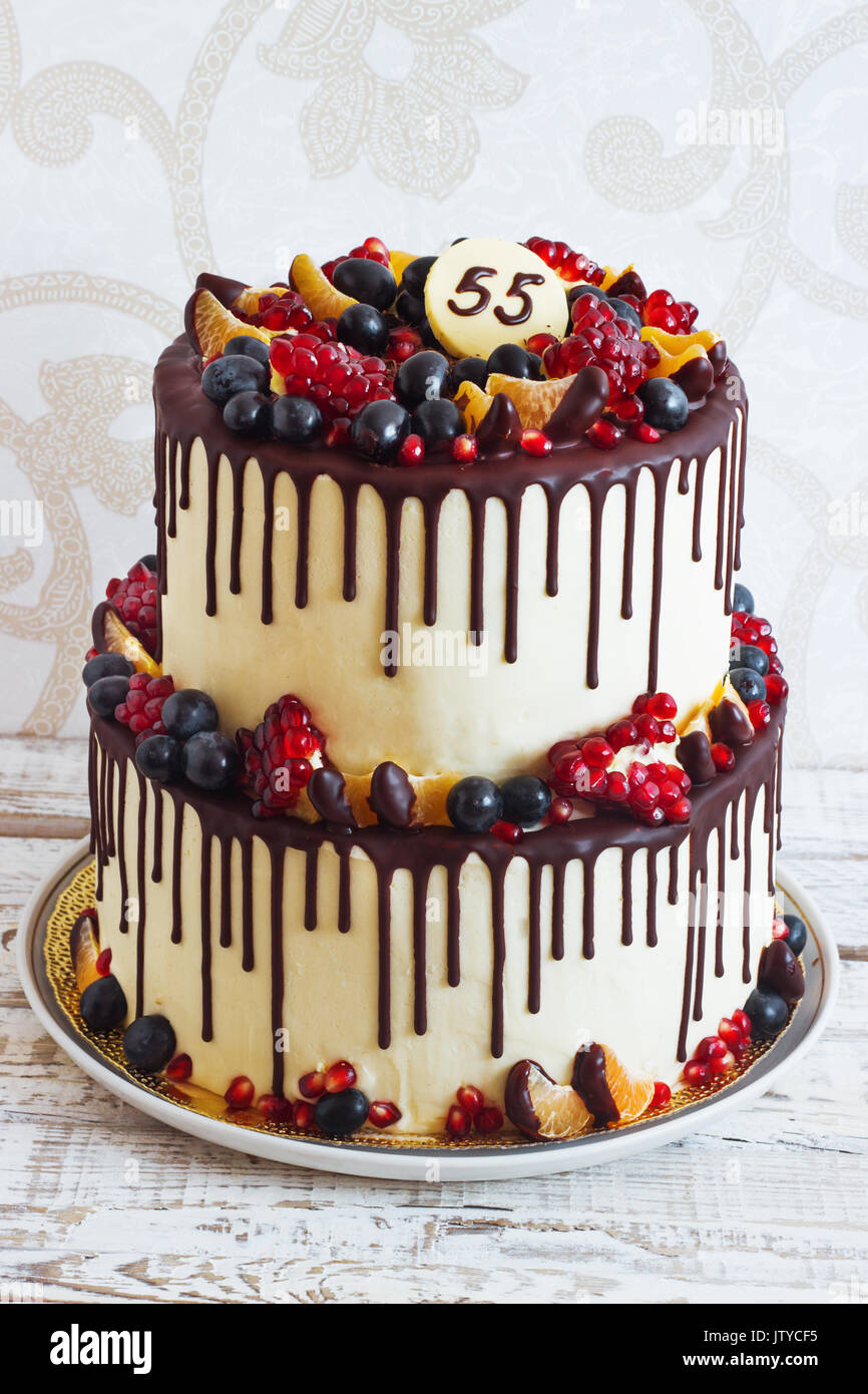 https://c8.alamy.com/comp/JTYCF5/festive-two-tier-cake-with-fruit-with-streaks-of-chocolate-on-a-light-JTYCF5.jpg