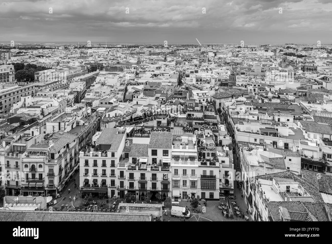 Seville, Spain - May 20, 2014: Aerial view of Sevilla, Spain, taken from Giralda tower in cloudy weather. Black and white photography. Stock Photo