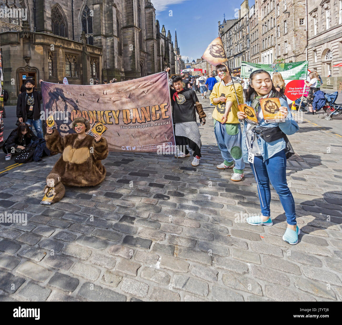 GGIRI & WINS from Korea promoting their show Monkey Dance at Edinburgh Festival Fringe 2017 in the High Street of the Royal Mile Edinburgh Scotland UK Stock Photo