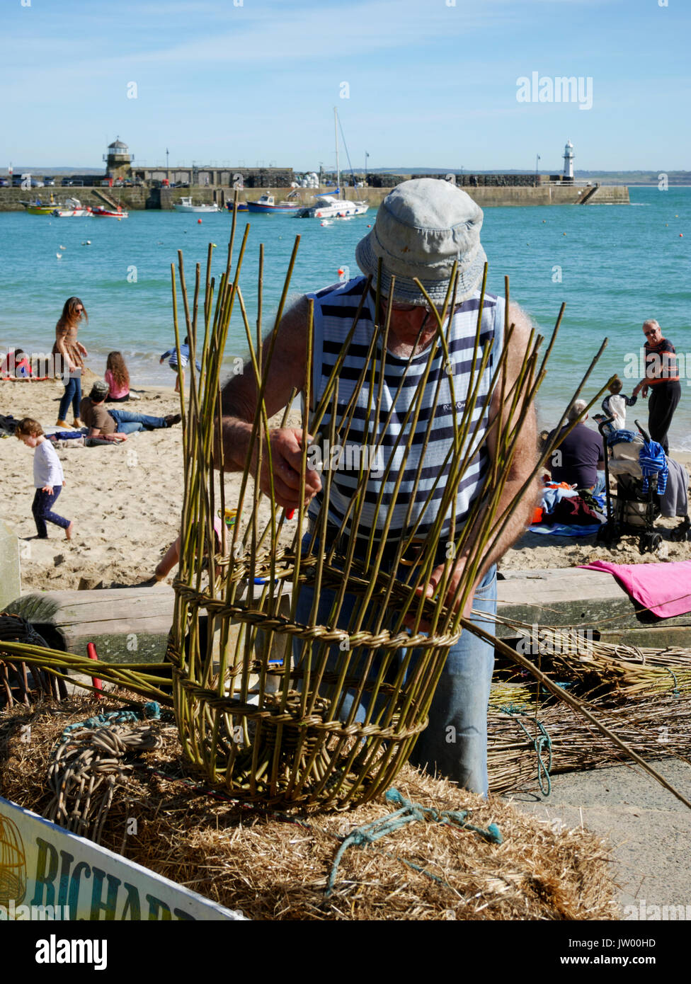 Cornish withy crab pot maker Richard Ede demonstrating his craft at St Ives, 25th March. Stock Photo