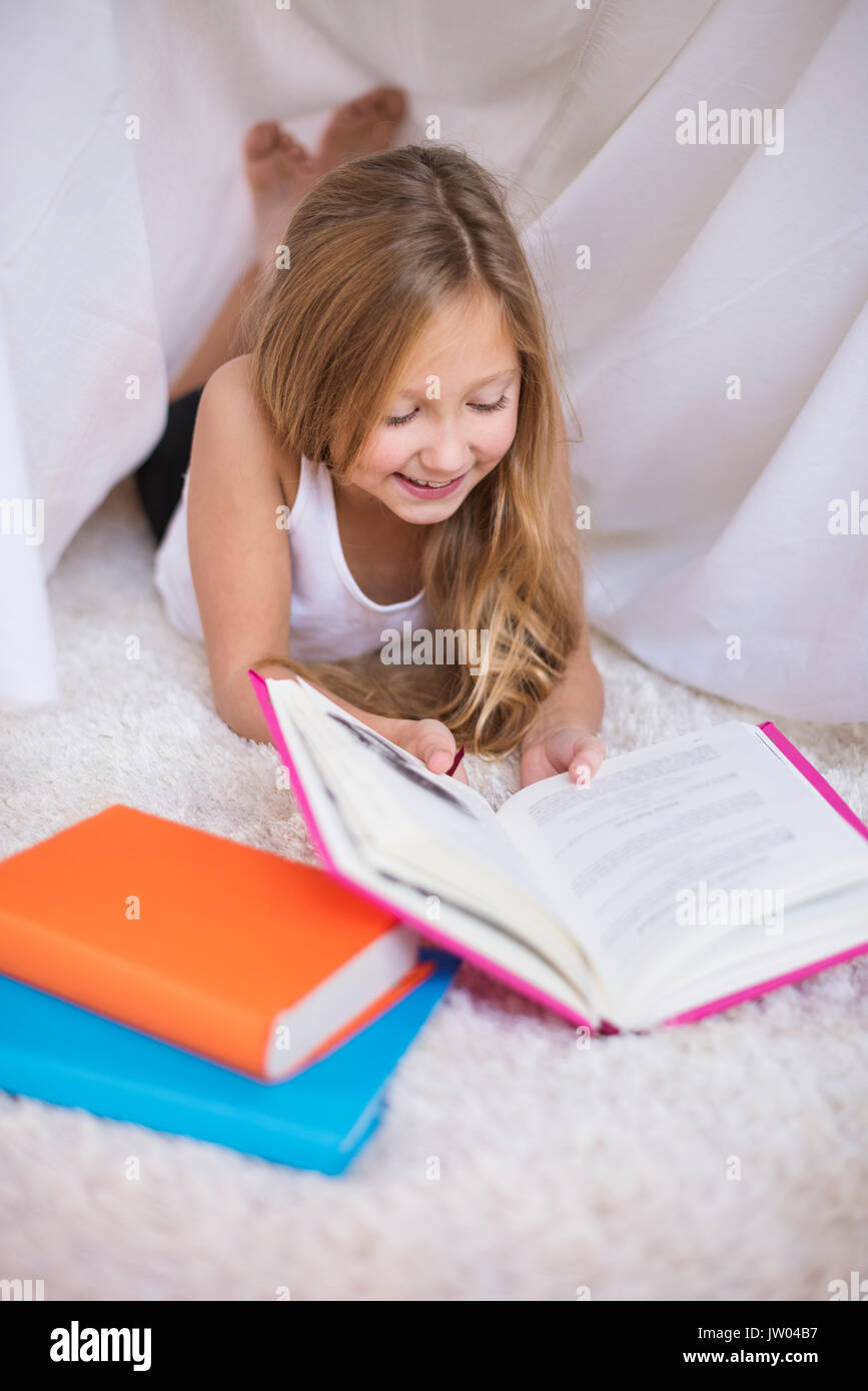 Elementary age girl reading a book Stock Photo