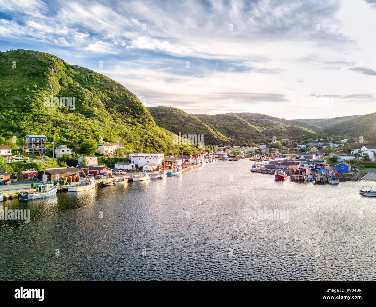 Charming Petty Harbour with green hills and colorful wooden architecture, Newfoundland, Canada Stock Photo