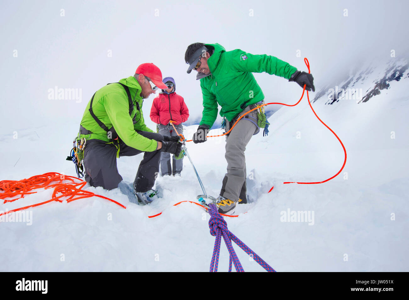 Denali National Park Service Ranger Dave Weber is showing rope techniques to Phunuru Sherpa. In 2009 the Nepalese mountain guide was the first to take part in the Sherpa Exchange Program, organized by the Khumbu Climbing Center to share mountaineering and rescue insights between Alaska and the Himalaya. In 2016 Phunuru came back to Denali. Stock Photo