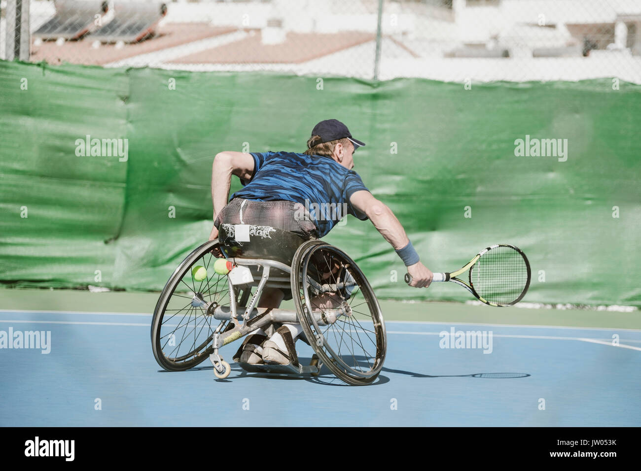 Mature Austrian paralympic tennis player playing on tennis court Stock Photo