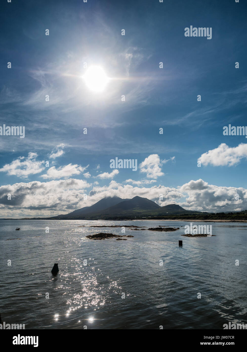 Croagh Patrick in clouds seen from Louisburgh small harbor in Ireland Stock Photo