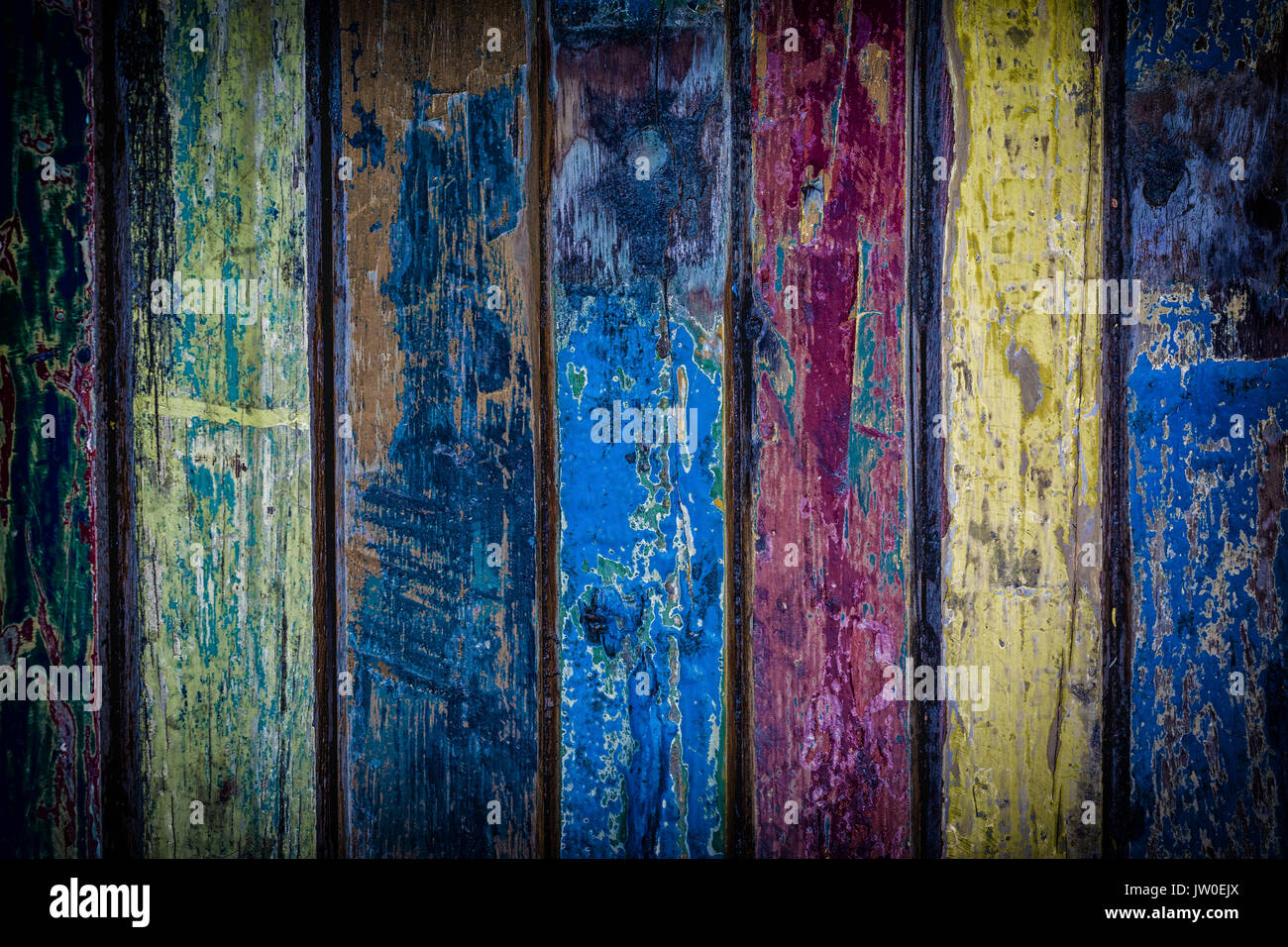 Multi colored board background with peeling paint. Stock Photo