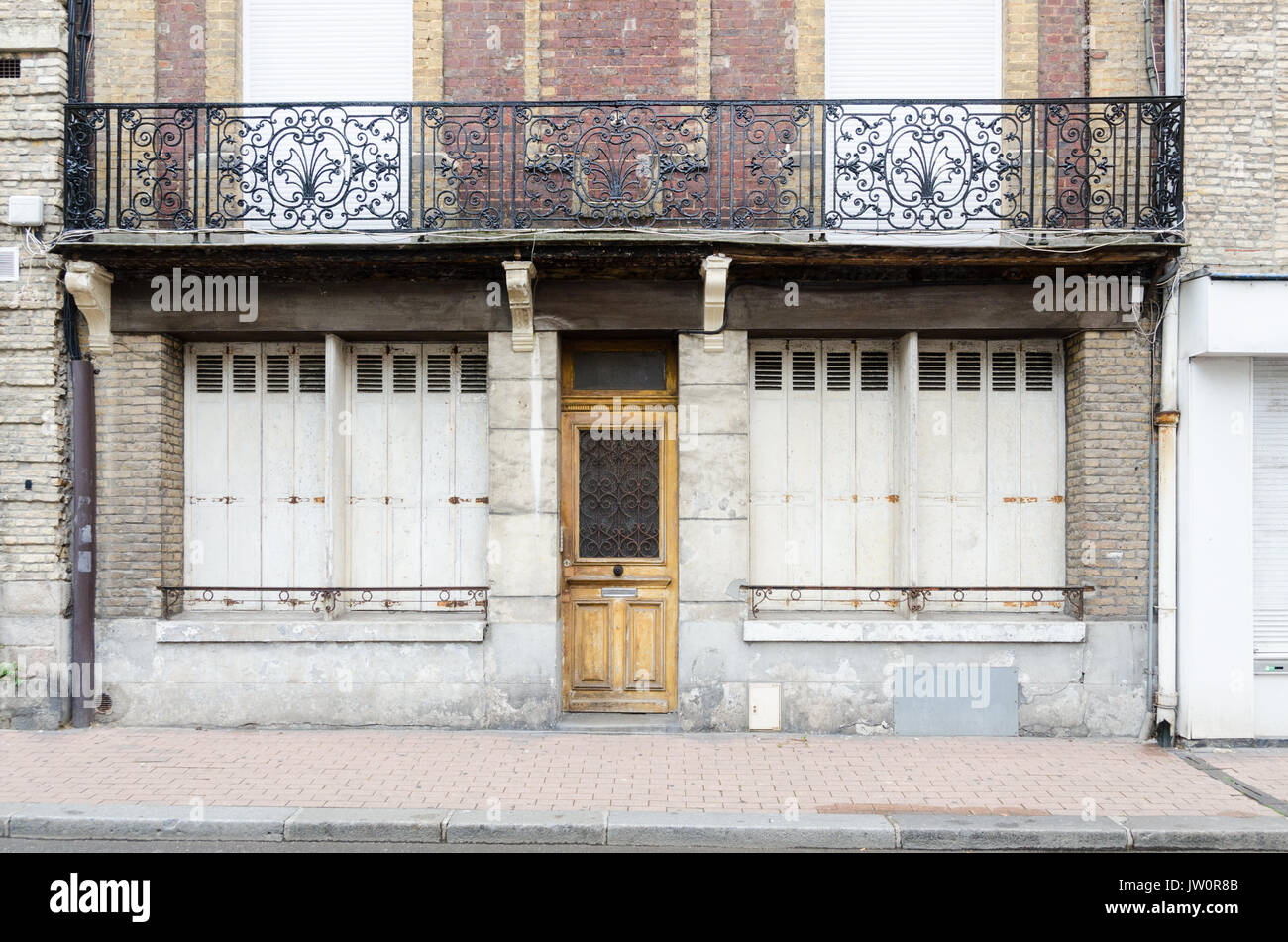 Old shop with shutters closed in French town in Pas de Calais, Northern France Stock Photo