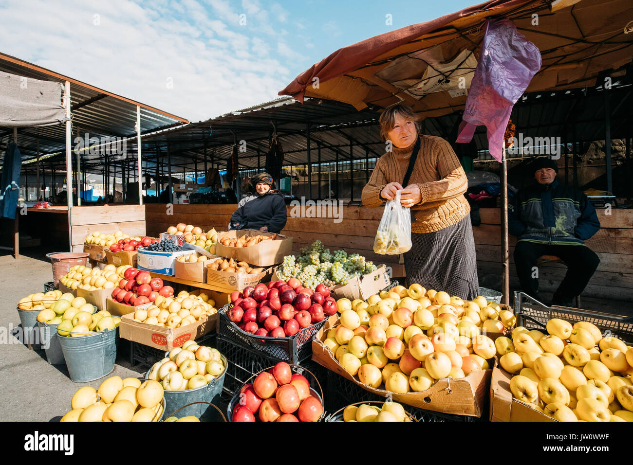 Gori, Shida Kartli Region, Georgia.  Woman Selling Fresh Fruits And Vegetables In Local Market In Sunny Autumn Day. Stock Photo