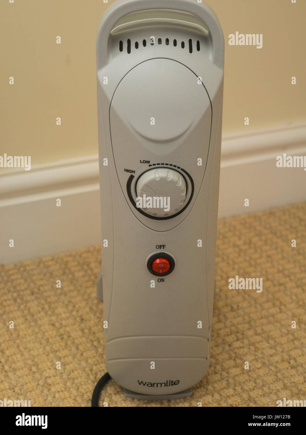 Small Warmlite oil filled home heater with adjustable heat control and  thermostat cut off Stock Photo - Alamy