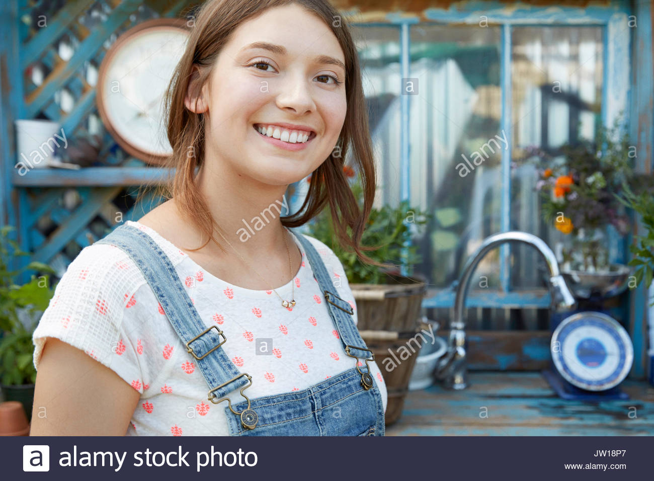 Portrait smiling Latina teenage girl in garden Stock Photo