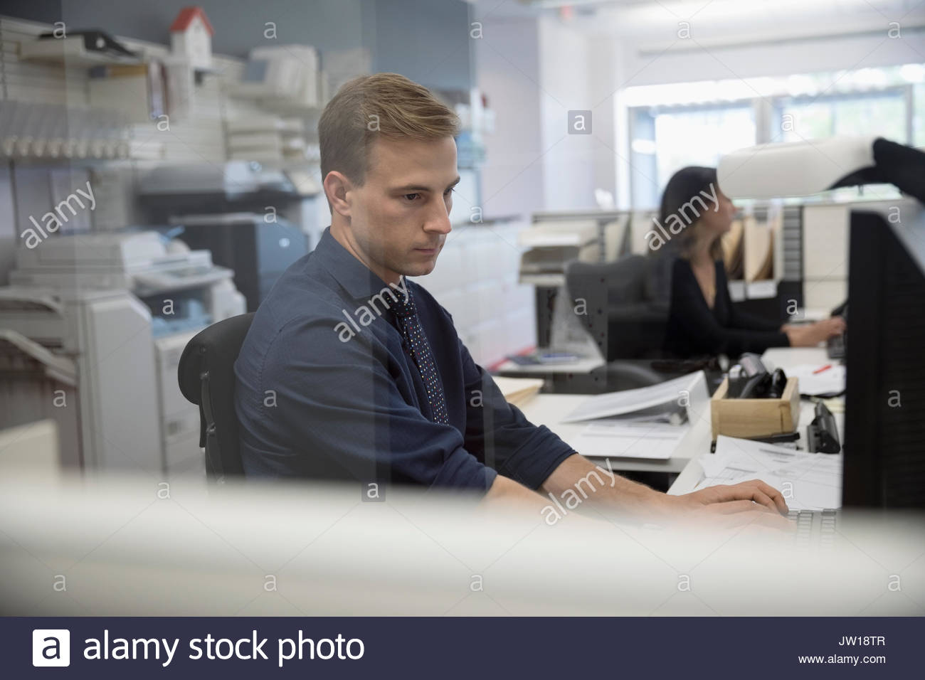 Serious young man using computer at hi-res stock photography and images ...