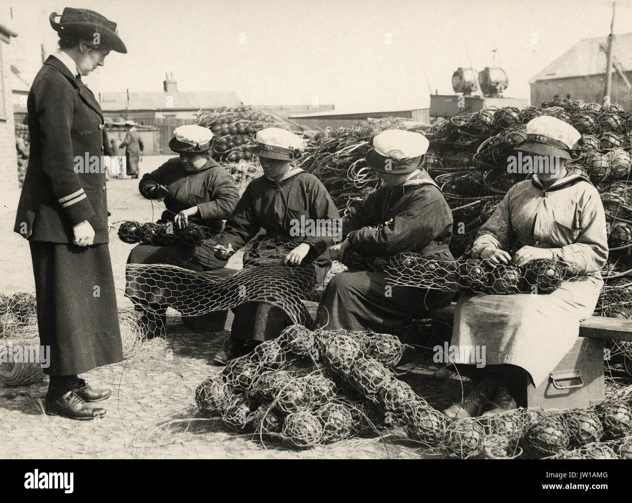 Mine net workers wiring the floats together - Alternative Title: Women ...