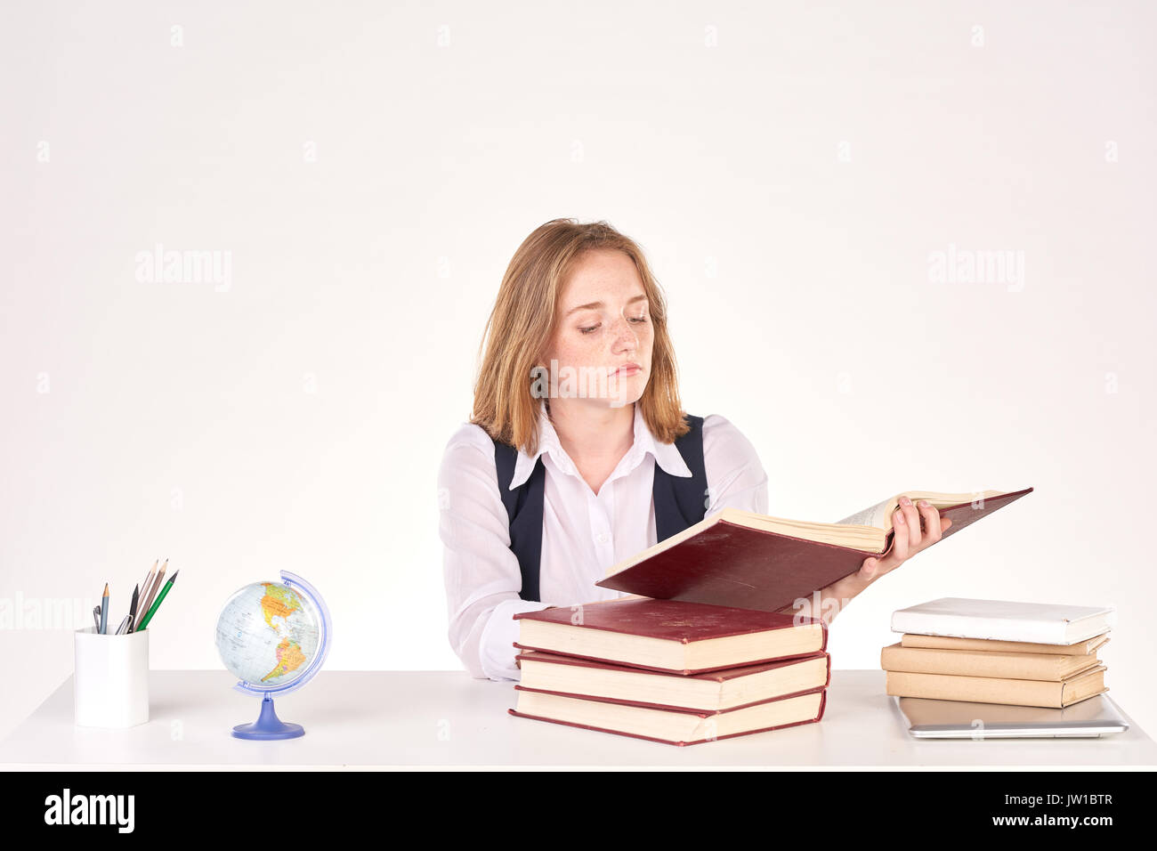 Girl studying at desk Stock Photo - Alamy