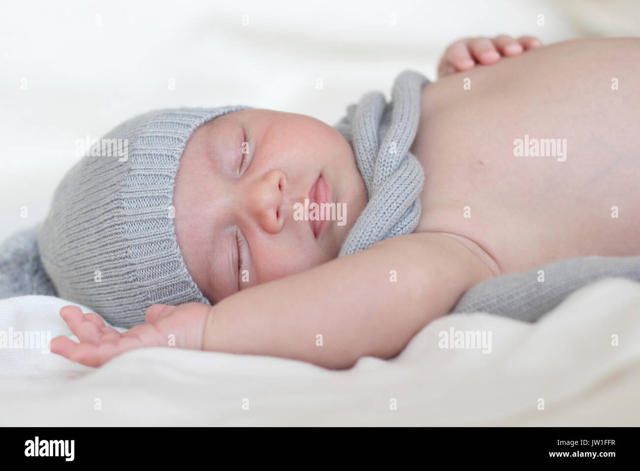 newborn with hat and scarf sleeping Stock Photo Alamy