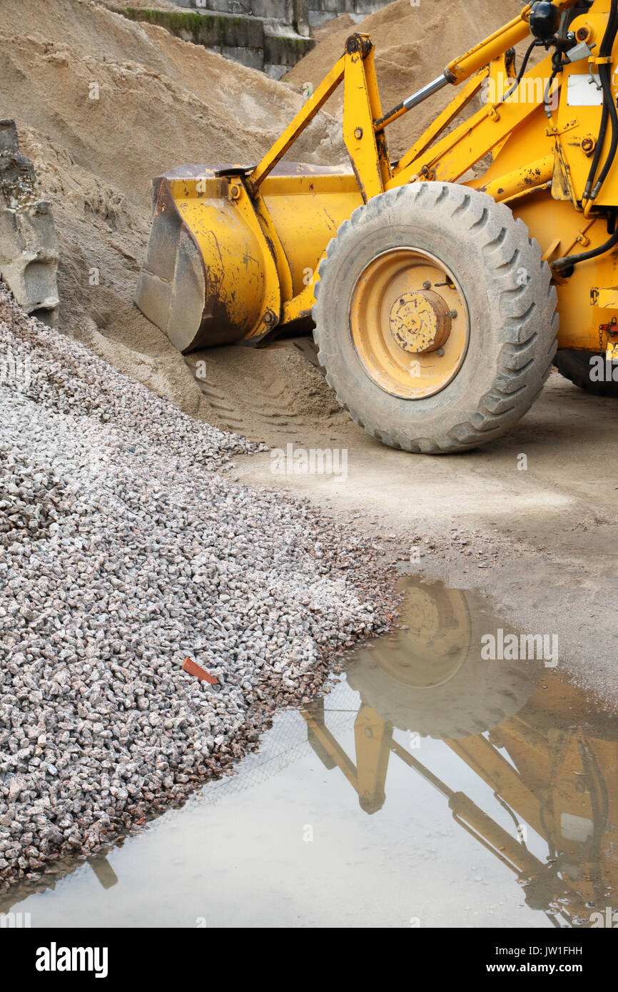 yellow excavator in the sand Stock Photo - Alamy